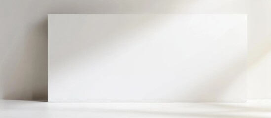 Poster - Close up of an empty white note paper on a clean white background for minimalist design or messaging purposes