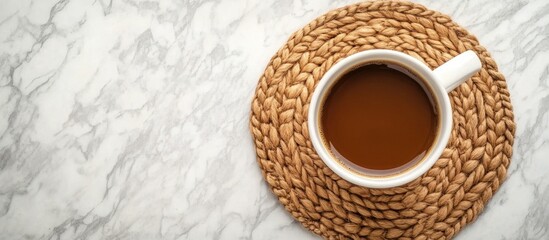 Aufkleber - Top view of a coffee cup on a round wooden coaster with a jute serving stand on a marble table background