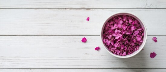 Aufkleber - Cup filled with aster petals on a rustic white wooden background Minimalist design Flat lay arrangement with flower petals
