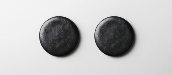 Poster - Top view of two black badges on a white background for design mockup showcasing real textures in a minimalistic style
