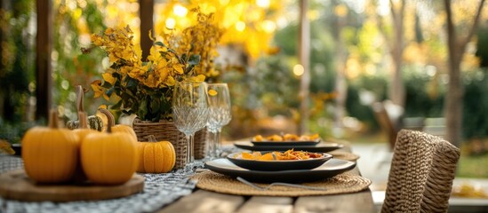 Poster - Charming Autumn Outdoor Table Setting with Pumpkins and Yellow Leaves Perfect for Seasonal Decor and Text Space