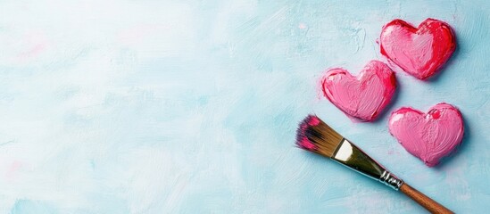 Poster - Pink Heart Decorations Painted with a Brush on a Light Blue Backdrop Featuring Open Space for Text or Creative Customization