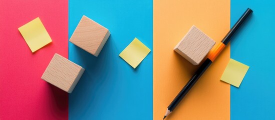 Poster - Flat lay arrangement of colored sticky notes, wooden blocks, and a pencil on vibrant backgrounds for creative workspace concept.