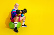 © deagreez - Full length photo banner of sportive cheerful old man lifting weights fitball dressed retro sportswear isolated on yellow color background