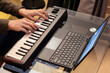 © princeoflove - man hands playing on music keyboard with laptop computer on desk. music education, music production concept