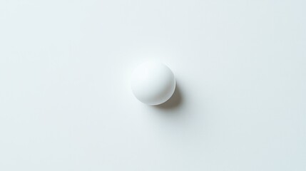 Poster - Round white object on a smooth white background with subtle shadow and soft lighting creating a minimalist aesthetic