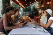 © bernardbodo - Tourists reading menu at restaurant in Rome