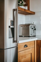 Wall Mural - Stainless steel fridge, toaster, wooden kitchen, flowers, interior design