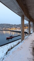 Canvas Print - Snowy harbor dawn, boat moored, city lights reflected, under bridge