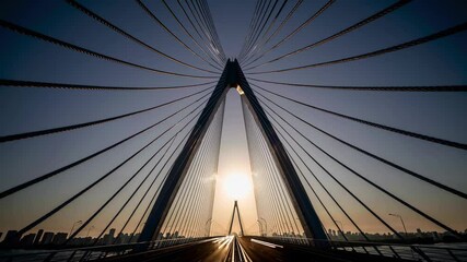 Aufkleber - Sunrise over a cable-stayed bridge illuminated by morning light in the city skyline