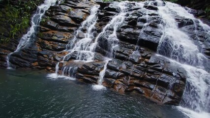 Aufkleber - Discovering a serene waterfall surrounded by lush greenery in a tropical jungle setting