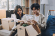 © ARMMY PICCA - Smiling couple unpacking boxes in new house