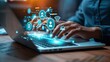 © N Joy Art  - Hands typing on a laptop keyboard with glowing blue 3D social media icons floating above, symbolizing interactive design, digital marketing, and modern networking solutions.