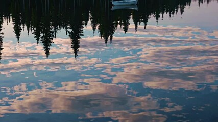 Poster - Reflections of trees and clouds on calm water at a serene lake during evening hours