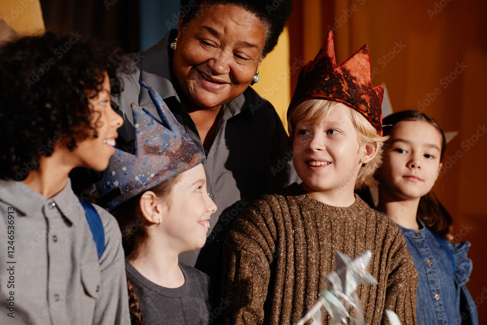 Diverse group of children smiling and celebrating under guidance of an ...