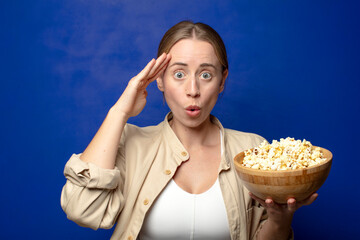 Wall Mural - young adult blonde woman with popcorns