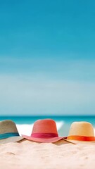 Poster - Vibrant beach hats lined up on sandy beach with a clear blue sky and serene ocean in the background. Emphasizes summer relaxation and vacation vibes