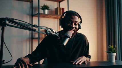 Poster - Professional content creator recording podcast episode, passionately speaking into microphone and gesturing dynamically in slow motion sequence within home studio environment