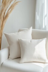 Poster - Soft plain pillows elegantly arranged on a smooth white chair creating a serene and inviting atmosphere