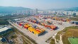 © MAGNIFIER - Aerial view of container yard with shipping containers of different sizes, logistics.