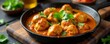 © Pawarit - Spicy chicken tikka masala curry in cast iron pan, indian food, flavorful, pan