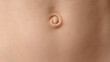 © SOLDATOOFF - Close-up of a baby's navel on smooth skin. Detailed skin texture, natural color, and soft lighting create a realistic appearance.