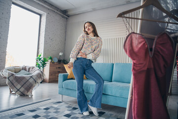 Young woman in casual attire enjoying relaxed time indoors in a cozy and stylish home setting