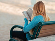 © Alberto GV PHOTOGRAP - woman sitting on a bench reading a physical book