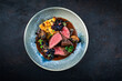 © HLPhoto - Barbecue dry aged venison steaks - deer entrecote cut English roasted with grilled mushrooms, fruit berry gravy sauce and panettone herbs served as top view on a design plate with copy
