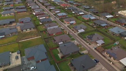 Wall Mural - Daytime drone shot captures a modern neighborhood, showcasing homes with green spaces and streets