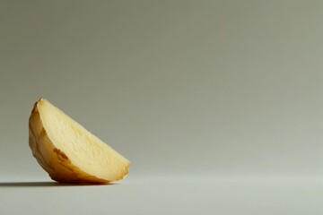 Poster - A close-up view of a single ginger slice reveals its unique texture and warm color, set against a clean white surface with ample copy space