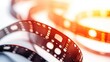 © Stockfish - A close-up of a film strip showcasing its perforations and frames, emphasizing vintage cinema.
