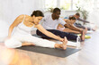 © JackF - Group of sports people of different nationalities do stretching during yoga or pilates class