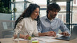 © Yuliia - Arabian female employer insurance agent consult Indian male client discuss business project finance marketing data on laptop two multiracial businesswoman and businessman corporate teamwork e-commerce