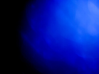 Wall Mural - blue color light leaks on dark background for design and special effects.