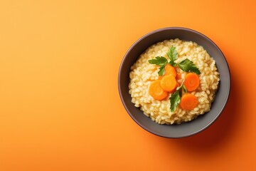 Wall Mural - Bowl of delicious risotto topped with carrots and parsley