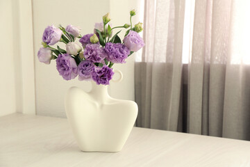 Wall Mural - Stylish vase with beautiful flowers on white wooden table at home, space for text