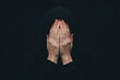 © jr-art - A man is wearing a black hoodie and is covering his face with his hands