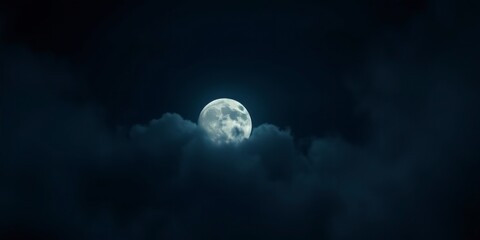 Wall Mural - A full moon partially obscured by clouds in a dark night sky