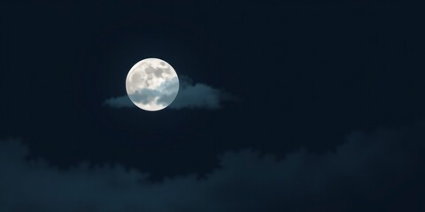 Wall Mural - A full moon partially obscured by clouds in a dark night sky