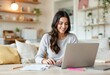 © AB02 - young woman working on her laptop at home