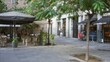 © Krakenimages.com - Defocused street scene in barcelona with blurred outdoor cafe seating and lush greenery under a mild bokeh effect enhancing the urban atmosphere of the european city.