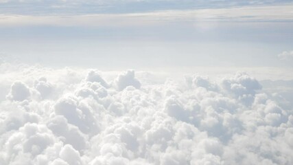 Wall Mural - blue sky with white fluffy clouds from airplane flight fly over the clouds in a sunny day with cloud moving in summer time