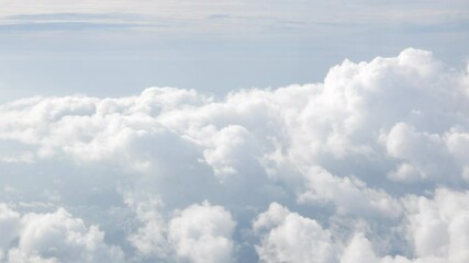 Wall Mural - blue sky with white fluffy clouds from airplane flight fly over the clouds in a sunny day with cloud moving in summer time