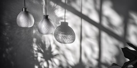 Aufkleber - Three light bulbs hanging on a wall next to a small plant, ideal for interior design or decorative purposes