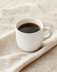 Wall Mural - Minimalist coffee cup on textured linen fabric, perfect for cozy moments