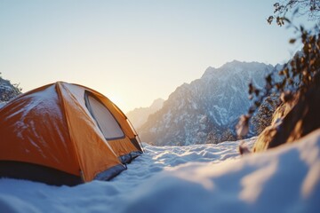 Wall Mural - A tent pitched up in the snow with mountains in the background, perfect for winter camping or outdoor adventure photography