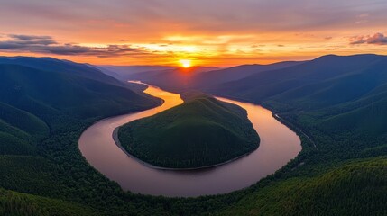 Aufkleber - A stunning aerial view of a winding river surrounded by lush green mountains, bathed in the warm glow of a vibrant sunset.