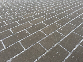 Wall Mural - A brick sidewalk with snow on it