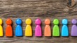 © Iswanto - Colorful figurines in a row on a wooden background, diversity concept, possible use for social media or presentations